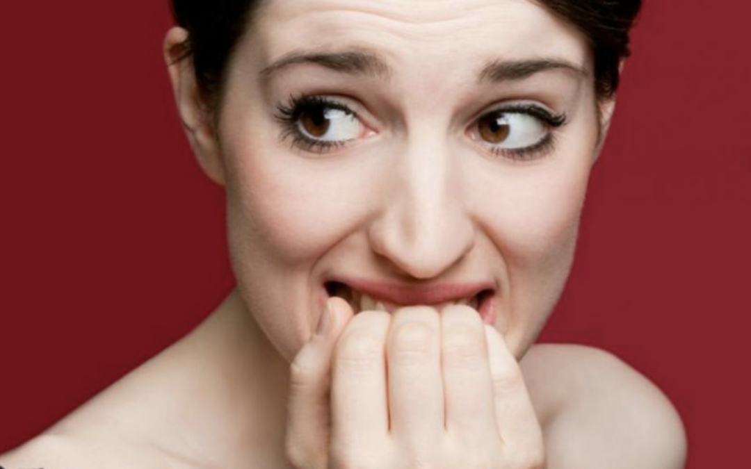 lady biting her nails, bad habit that damages teeth